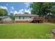 Expansive backyard featuring a well-maintained lawn and a wooden deck, perfect for outdoor enjoyment at 317 Sugar Creek Xing, Fort Mill, SC 29715