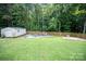 Spacious backyard with a shed, firepit and an area for firewood storage, all enclosed by a wood fence at 317 Sugar Creek Xing, Fort Mill, SC 29715
