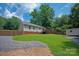 Large, grassy backyard with a wooden fence, offering ample space for recreation and relaxation at 317 Sugar Creek Xing, Fort Mill, SC 29715