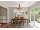 Bright dining area with rustic table, decorative lighting, and sliding door to the patio at 317 Sugar Creek Xing, Fort Mill, SC 29715