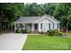 Charming single-Gathering home with light siding, blue shutters, beautiful front yard, and covered porch at 317 Sugar Creek Xing, Fort Mill, SC 29715
