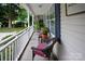 Relaxing covered front porch with comfortable wicker seating and a view of the landscaped front yard at 317 Sugar Creek Xing, Fort Mill, SC 29715