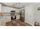 Well-lit kitchen featuring stainless steel appliances, white cabinets, and granite countertops at 317 Sugar Creek Xing, Fort Mill, SC 29715