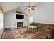 Spacious living room with vaulted ceiling, fireplace, built-in shelves, and hardwood flooring at 317 Sugar Creek Xing, Fort Mill, SC 29715