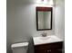 A half-bathroom featuring a wood vanity, white countertop, stainless steel faucet, and a modern sink at 3837 1St Street Nw Ln, Hickory, NC 28601
