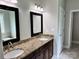 A primary bathroom features dual sinks, granite countertops, framed mirrors, and tile flooring at 3837 1St Street Nw Ln, Hickory, NC 28601
