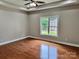 Bright bedroom with hardwood floors, a ceiling fan and a window overlooking the backyard at 3837 1St Street Nw Ln, Hickory, NC 28601