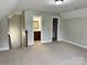 Bonus room with neutral carpet, paint, and an ensuite bathroom, offering a flexible living space at 3837 1St Street Nw Ln, Hickory, NC 28601