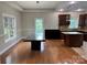 Dining area featuring wood floors, modern lighting, and access to the adjacent kitchen at 3837 1St Street Nw Ln, Hickory, NC 28601