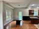 Dining area featuring wood floors, modern lighting, and access to the adjacent kitchen at 3837 1St Street Nw Ln, Hickory, NC 28601