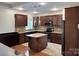 Kitchen boasts stainless appliances, an island, tile backsplash, and beautiful wood cabinetry at 3837 1St Street Nw Ln, Hickory, NC 28601