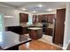 A kitchen with dark cabinets, granite countertops, pendant lighting, a kitchen island, and stainless steel appliances at 3837 1St Street Nw Ln, Hickory, NC 28601