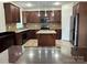 Kitchen boasts stainless appliances, an island, tile backsplash, and beautiful wood cabinetry at 3837 1St Street Nw Ln, Hickory, NC 28601