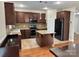 Kitchen boasts stainless appliances, an island, tile backsplash, and beautiful wood cabinetry at 3837 1St Street Nw Ln, Hickory, NC 28601