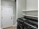 Well-lit laundry room with washer, dryer and shelving for storage at 3837 1St Street Nw Ln, Hickory, NC 28601