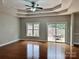 Bright living room with hardwood floors, trey ceiling, a ceiling fan and access to the outdoor deck at 3837 1St Street Nw Ln, Hickory, NC 28601