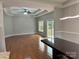Bright living room with hardwood floors, trey ceiling, a ceiling fan and access to the outdoor deck at 3837 1St Street Nw Ln, Hickory, NC 28601