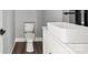 Contemporary bathroom features a toilet with wooden floors and a sleek, rectangular vessel sink at 405 E Broad St, Salisbury, NC 28144