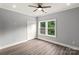 This bedroom has a ceiling fan, a large window, and a closet at 405 E Broad St, Salisbury, NC 28144