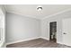 Bright bedroom with gray walls, crown molding, wood floors, and an ensuite bathroom at 405 E Broad St, Salisbury, NC 28144