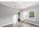 Bedroom with gray walls, wood floors, a window, and a doorway leading to other rooms at 405 E Broad St, Salisbury, NC 28144