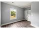 Cozy bedroom featuring a large window overlooking the yard and multiple closets for storage at 405 E Broad St, Salisbury, NC 28144