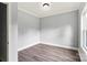 An empty bedroom with a clean, gray paint job, modern floors, and a single window at 405 E Broad St, Salisbury, NC 28144