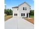 Charming two-story home with white siding, a large driveway, and a manicured lawn at 405 E Broad St, Salisbury, NC 28144