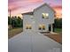 Charming two-story home with white siding, a large driveway, and a manicured lawn at 405 E Broad St, Salisbury, NC 28144