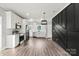 Modern kitchen with stainless steel appliances, white cabinets, and stylish dark accent wall at 405 E Broad St, Salisbury, NC 28144