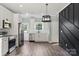Modern kitchen with stainless steel appliances, white cabinets, and stylish dark accent wall at 405 E Broad St, Salisbury, NC 28144