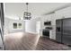 Modern kitchen with stainless steel appliances, white cabinets, and a stylish lighting fixture at 405 E Broad St, Salisbury, NC 28144