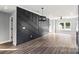 Chic open living area showcasing dark accent wall, modern lighting, and lovely hardwood floors at 405 E Broad St, Salisbury, NC 28144