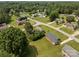 Aerial view of homes on tree-lined streets with mature landscaping and swimming pool at 416 Park Ave, Granite Quarry, NC 28072