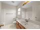 Bright bathroom featuring a neutral color scheme, white sink, and a wooden vanity at 416 Park Ave, Granite Quarry, NC 28072