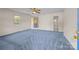 Bright bedroom with plush blue carpet, a ceiling fan, and neutral wall paint at 416 Park Ave, Granite Quarry, NC 28072