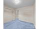 Bedroom with soft, light blue carpeting, double closets, and a bright, neutral color scheme at 416 Park Ave, Granite Quarry, NC 28072