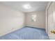 A bedroom featuring a window that lets in natural light and soft, light blue carpeting at 416 Park Ave, Granite Quarry, NC 28072