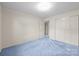 Bedroom featuring soft, light blue carpets, a neutral color scheme, and double closets at 416 Park Ave, Granite Quarry, NC 28072