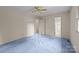 A bedroom with soft, light blue carpets, a ceiling fan, and double closets at 416 Park Ave, Granite Quarry, NC 28072
