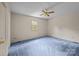 Comfortable bedroom with soft, light blue carpets, neutral walls, and a ceiling fan at 416 Park Ave, Granite Quarry, NC 28072