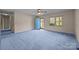 Bright bedroom with blue carpet, a ceiling fan, and a blue front door at 416 Park Ave, Granite Quarry, NC 28072