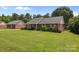 Charming brick home with a lush lawn, blue shutters, and a private, tree-lined yard at 416 Park Ave, Granite Quarry, NC 28072