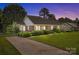 Charming brick home with a well-manicured lawn, mature landscaping, and a private driveway at 416 Park Ave, Granite Quarry, NC 28072