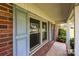 Cozy front porch view featuring a blue front door, brick detail, and a covered entrance at 416 Park Ave, Granite Quarry, NC 28072