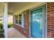 Inviting front porch featuring a blue door, brick facade, and white columns at 416 Park Ave, Granite Quarry, NC 28072