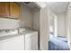 Convenient laundry area with modern washer, dryer, and a storage cabinet at 416 Park Ave, Granite Quarry, NC 28072