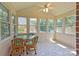 Sunroom with lots of natural light, a glass top table, and four chairs at 416 Park Ave, Granite Quarry, NC 28072