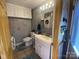 Bathroom showcasing a vanity, a toilet, and stacked laundry machines at 4303 Grier St, Gastonia, NC 28056