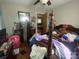 Cluttered bedroom featuring a large bed, dresser, and personal items at 4303 Grier St, Gastonia, NC 28056